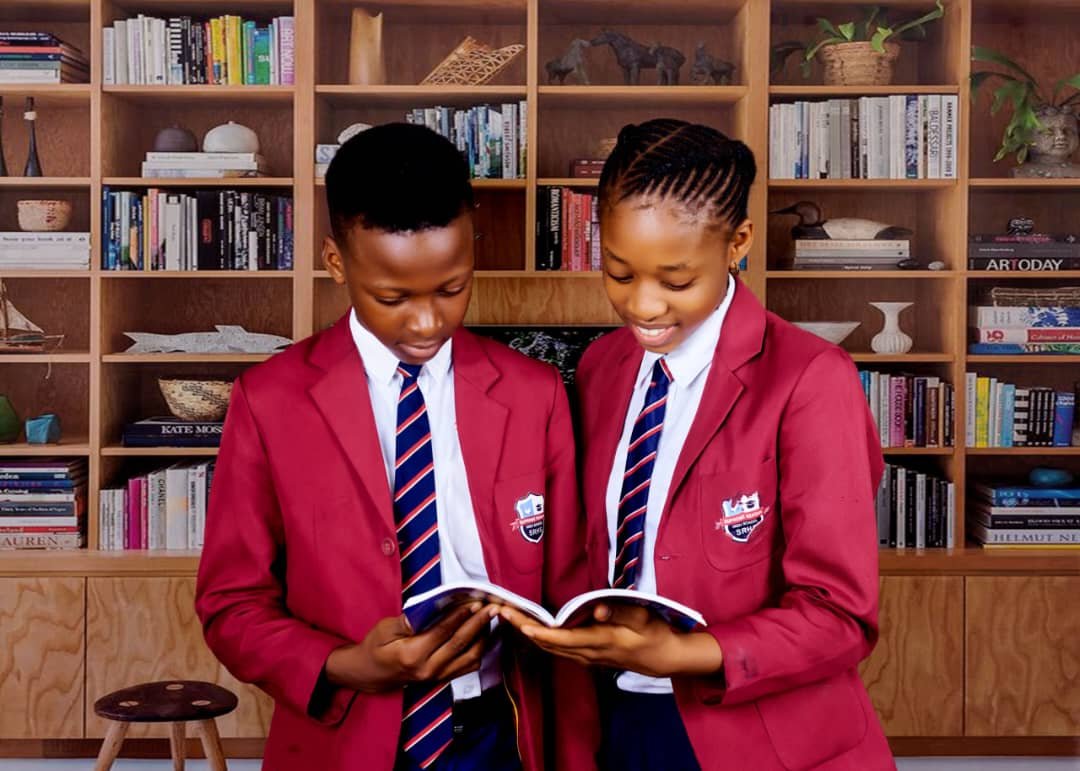 Supreme Reagan Schools pupils studying together in the library